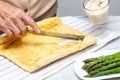 Close up of a senior woman hands stuffing a just baked sponge cake