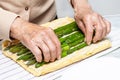 Close up of a senior woman hands stuffing a just baked sponge cake