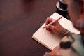 Close Up Of Senior Woman At Home Sitting At Table And Writing In Notebook Or Journal Royalty Free Stock Photo