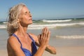 Close up of senior woman meditating at beach Royalty Free Stock Photo