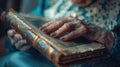 Close-up of a senior woman's hand touching a photo album, with visible distress, conveying the emotional impact of