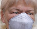 Close up senior woman scared look,  wearing face mask during corona virus and flu outbreak. Disease and illness protection Royalty Free Stock Photo