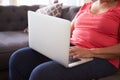 Close Up Of Senior Woman Sitting On Sofa Using Laptop Royalty Free Stock Photo