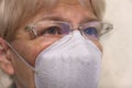 Close up senior woman wearing glasses and face mask during corona virus and flu outbreak. Royalty Free Stock Photo