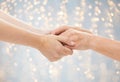 Close up of senior and young woman holding hands Royalty Free Stock Photo