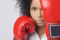 Close up of serious African American girl with red boxing gloves