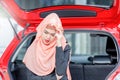 Close up of serious beautiful Arab middle eastern businesswoman sitting at the rear part of modern car