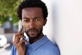 Close up serious black man talking on mobile phone outside Royalty Free Stock Photo