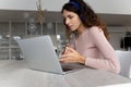 Close up serious businesswoman in headphones using laptop, video call Royalty Free Stock Photo