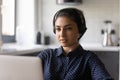 Close up serious confident Indian woman wearing headset using laptop Royalty Free Stock Photo