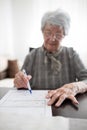 Close-up of a serious senior woman`s hands doing Alzheimer`s disease or dementia self assessment test at home Royalty Free Stock Photo