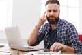 Close up of a serious male IT manager is reading report, while is sitting at the table with open net-book. Royalty Free Stock Photo