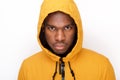 Close up serious young black man with rain coat against white background Royalty Free Stock Photo