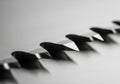 Close-up of serrated metal teeth arranged linearly on a knife blade. The surface is polished and Royalty Free Stock Photo