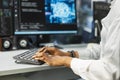 Close up of server farm worker typing on PC keyboard, deploying deep learning Royalty Free Stock Photo