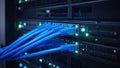 Close-up of server rack with blue network cables connected in a data center. Royalty Free Stock Photo