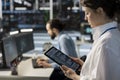 Close up of server room programmer using tablet to pinpoint performance issues Royalty Free Stock Photo