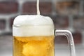 Close up Serving a refreshing beer mug with foam on a white bar Royalty Free Stock Photo