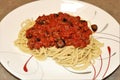 Close-up of Spaghetti and Meat Sauce on Red and White Plate Royalty Free Stock Photo