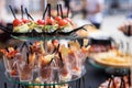 The close up of a set of canapes and snack at a banquet with black table