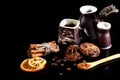 Close-up set of coffee dishes, espresso coffee, milk and cocoa spoon, round crunchy chocolate cookies with coffee beans, sticks of