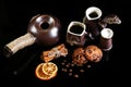 Close-up set of coffee dishes, espresso coffee, milk and cocoa spoon, round crunchy chocolate cookies with coffee beans, sticks of