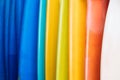 Close up Set of different color surf boards in a stack on sandy beach for rent. Multicolored surfboards as rainbow Royalty Free Stock Photo