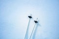 Bottoms of a mountain ski pair poles in the snow view from above