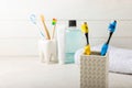 Close-up of a set of multicolored toothbrushes in a glass on a gray background. Royalty Free Stock Photo