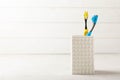 Close-up of a set of multicolored toothbrushes in a glass on a gray background. Royalty Free Stock Photo