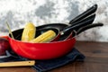 close up of a set of red pans with vegetables Royalty Free Stock Photo