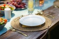 Close up of set table at a summer garden party. Table setting with glasses, lemonade, fresh fruits and salad and