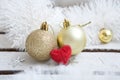 Close up of several Christmas gold glass baubles with red heart Royalty Free Stock Photo
