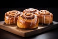 Close-up of several cinnamon buns on a wooden grunge texture table.