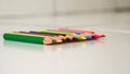 Close up of several colored pencils arranged on paper Royalty Free Stock Photo