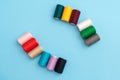 Close-up of several colored spools of sewing thread as a concept of different people in one common business Royalty Free Stock Photo