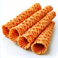 A close up of several waffle cone straws stacked on a white surface in a diagonal arrangement Royalty Free Stock Photo