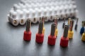 Close up several Wire Ferrule and terminal block w wire on top of a black table