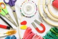 Close-up sewing and embroidery kit with threads and needle, button, scissors and fabrics on frame Royalty Free Stock Photo