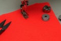 Close up. Sewing machine foot, bobbins, scissors. Coral background. Copy space