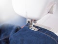 Close up sewing machine sew seam of blue denim jean Royalty Free Stock Photo