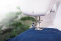 Close up sewing machine sew seam of blue denim jean Royalty Free Stock Photo