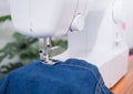 Close up sewing machine sew seam of blue denim jean Royalty Free Stock Photo