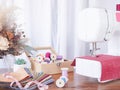 Close up sewing machine working with red fabric, sewing accessories on the table, stitch new clothing Royalty Free Stock Photo