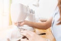 Close-up of sewing process, hands of seamstress hold fabric