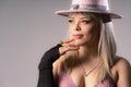 Close-up of sexy blonde woman in pink hat and lingerie, wearing jewelry and wearing black gloves Royalty Free Stock Photo