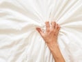 Close up sexy woman hand pulling and squeezing white sheets in ecstasy in bed. Orgasm on white bed. Sex and erotic Royalty Free Stock Photo