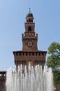 Close up of Sforza Castle with a water fountain in front of the tower, fortification in the historic center of Milan Royalty Free Stock Photo