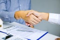 Close up of shaking hands with customer and real estate broker after signing a contract in home office Royalty Free Stock Photo