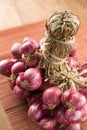 Close up shallots on wood and bamboo background. Royalty Free Stock Photo